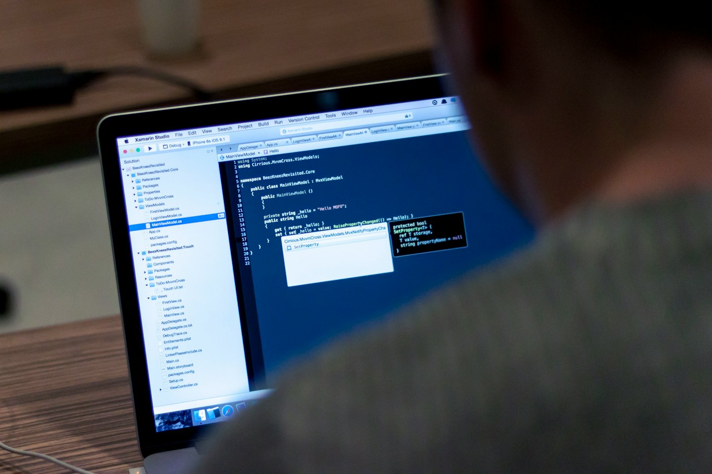 Software developer typing code on a laptop.